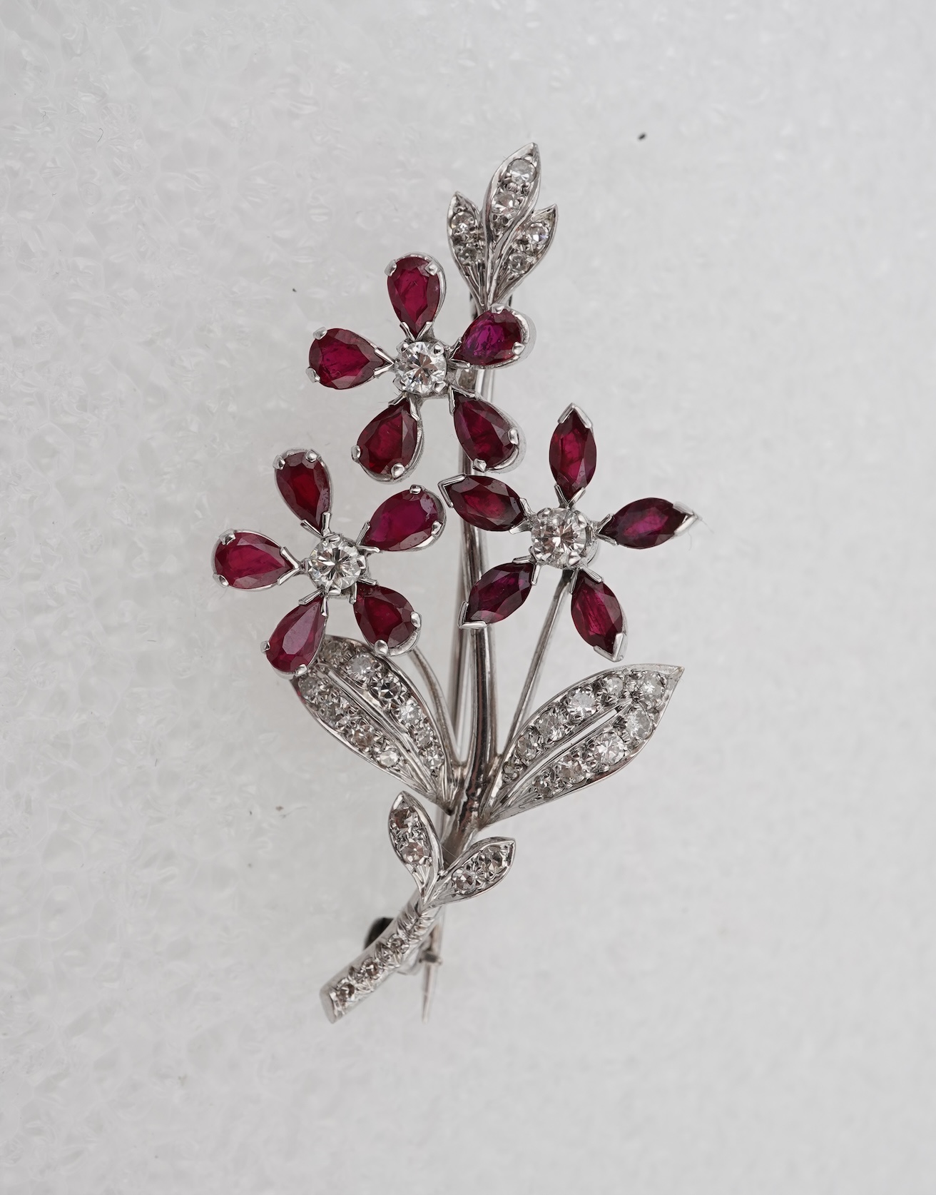 A ruby and diamond floral spray brooch